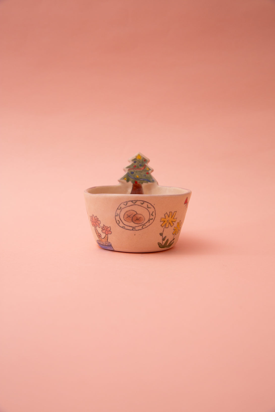 ceramic bowl with floral patterns on a pink background