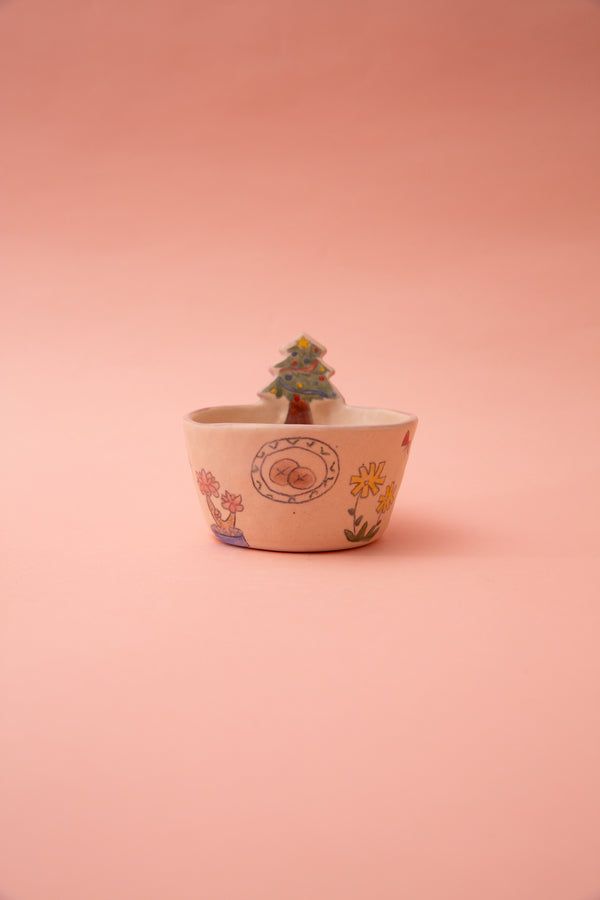 ceramic bowl with floral patterns on a pink background