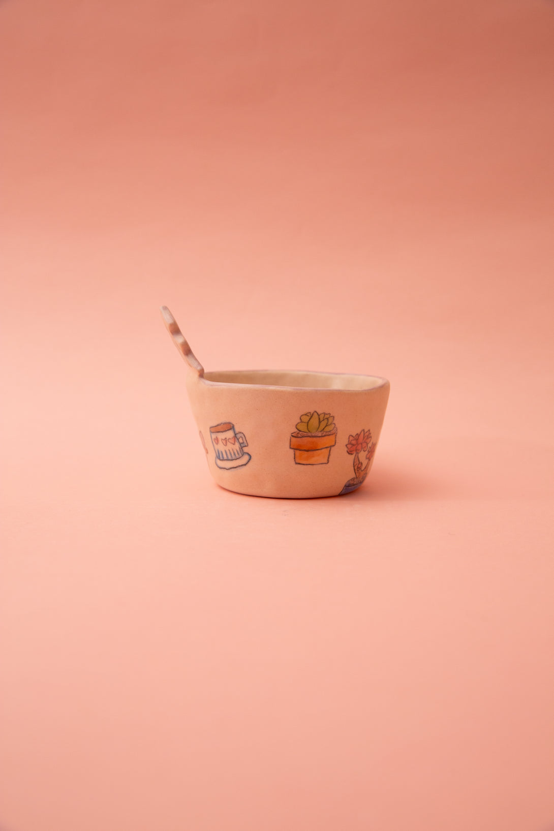Ceramic bowl with illustrations on a pink background