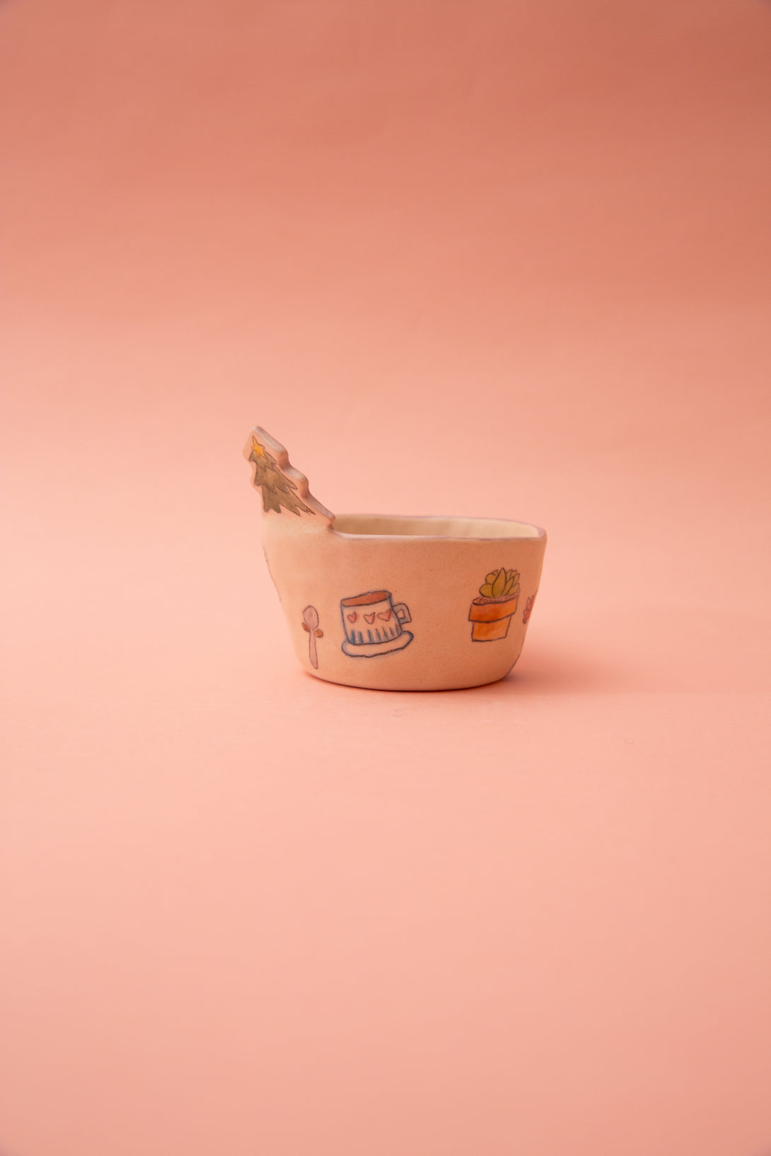 Small ceramic bowl with illustrations on a pink background