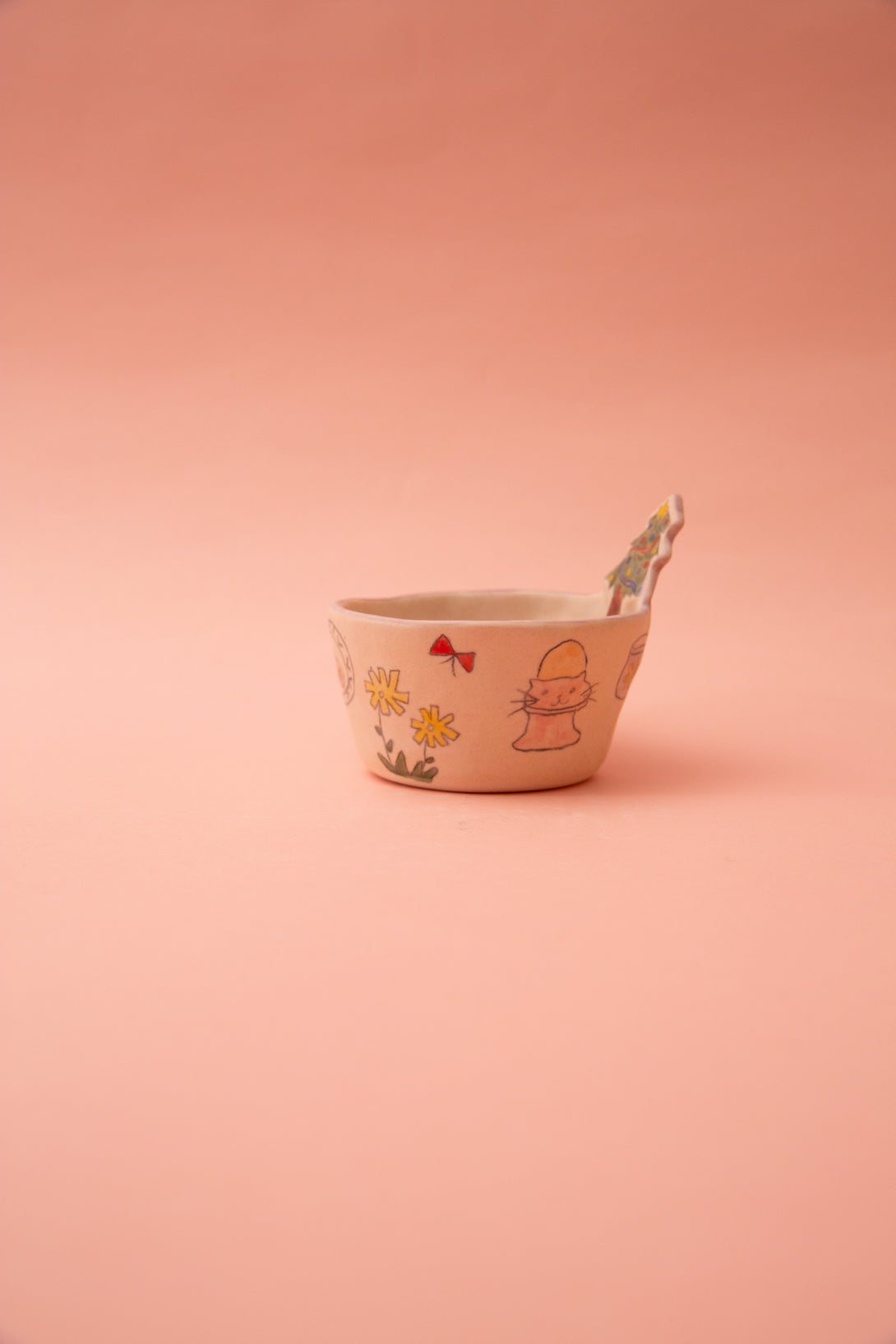 Ceramic bowl with illustrations on a pink background