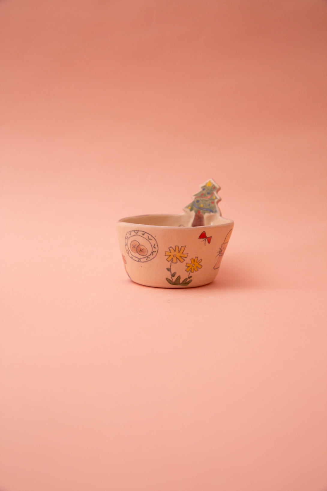 Small bowl with floral design on a pink background