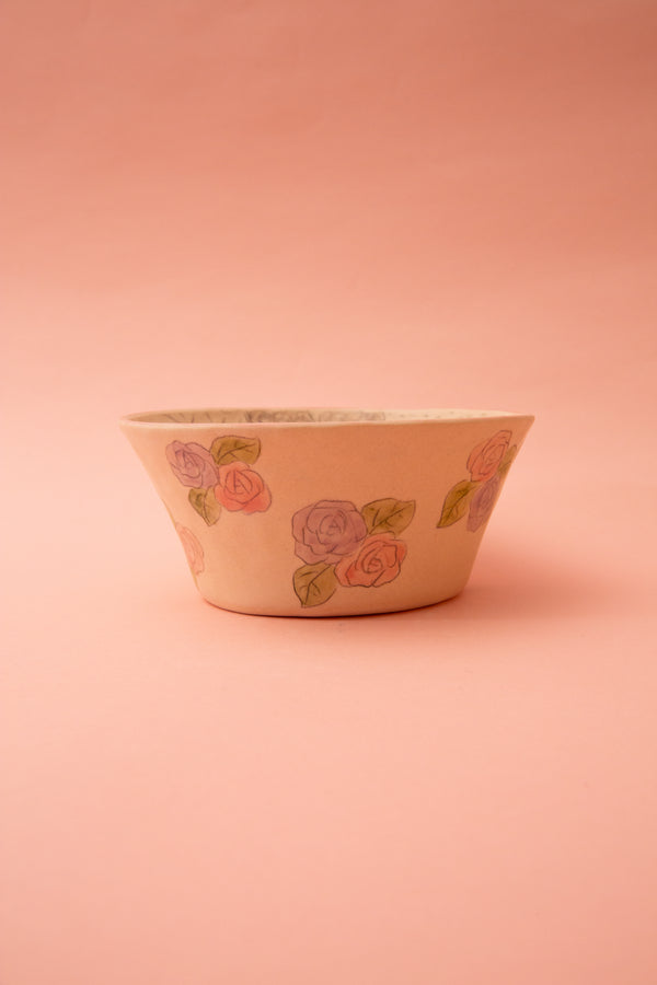 Ceramic bowl with floral design on a pink background
