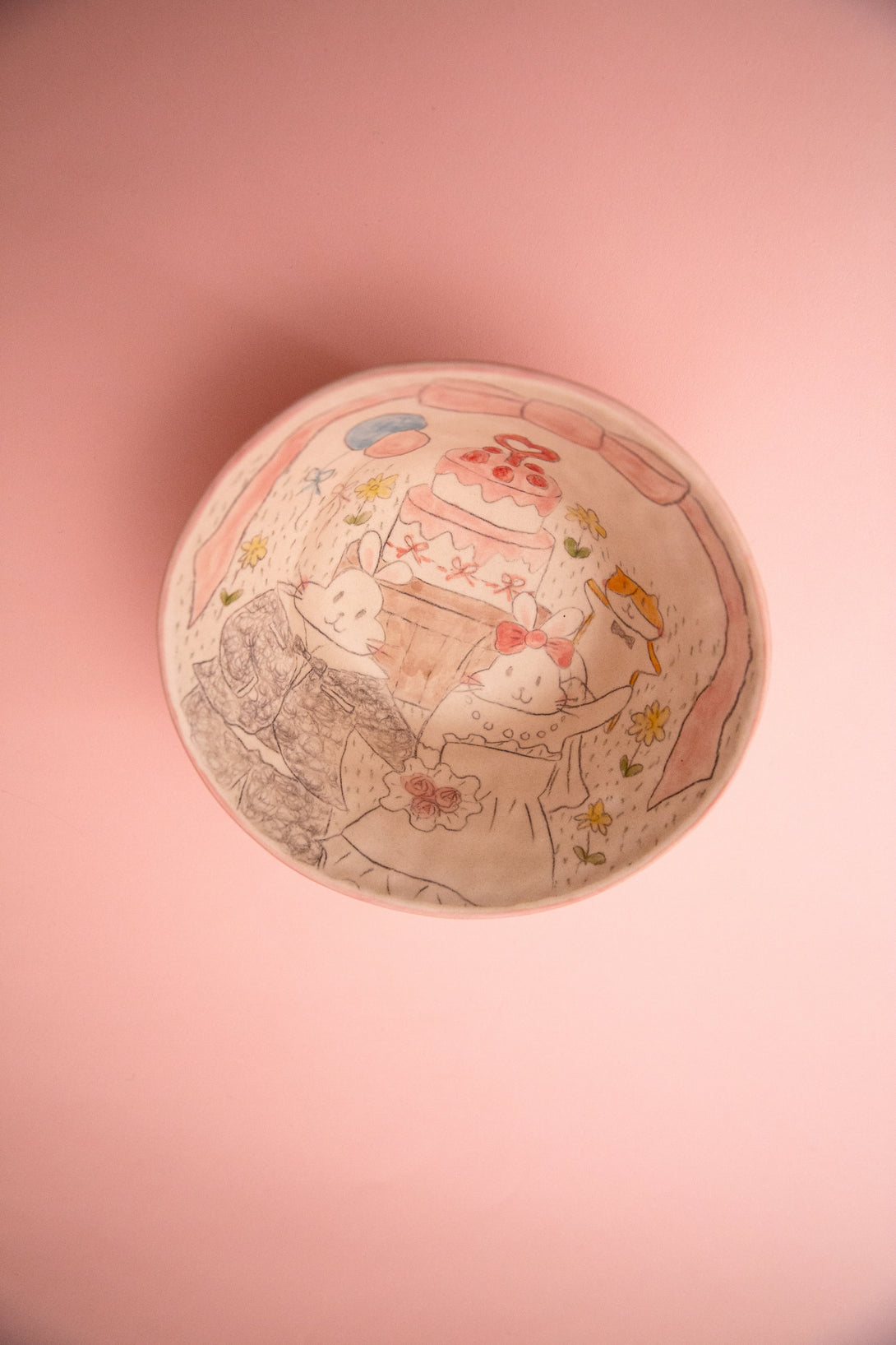 Ceramic bowl with cartoon characters on a pink background