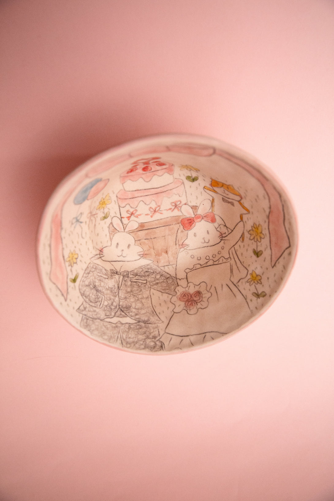 Ceramic bowl with cartoon characters on a pink background