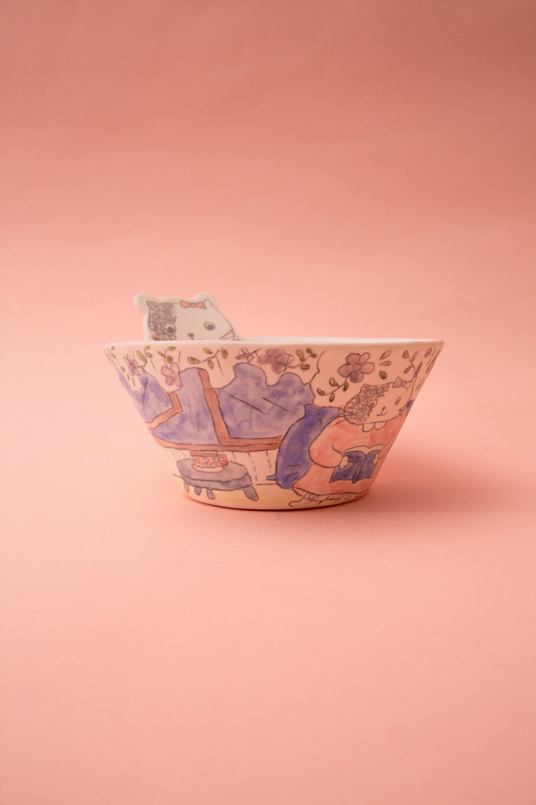 Ceramic bowl with a cartoon design on a pink background