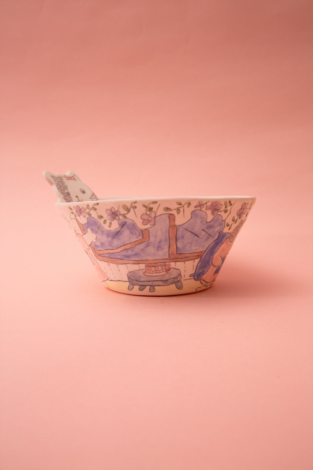 Ceramic bowl with blue and white design on a pink background