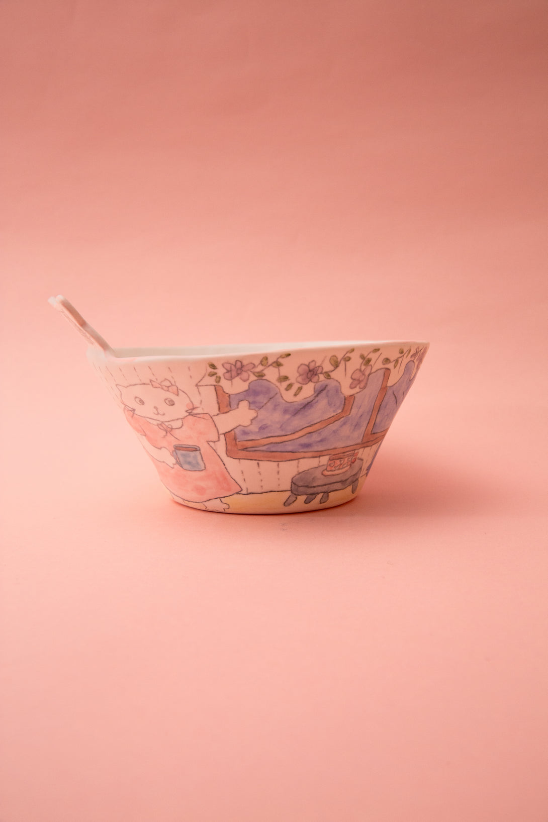 Ceramic bowl with artistic design on a pink background