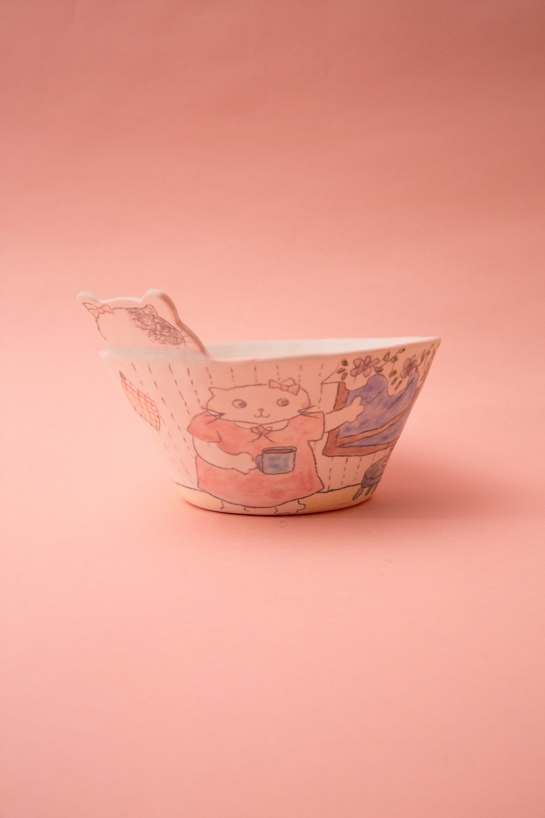 Ceramic bowl with cartoon design on a pink background