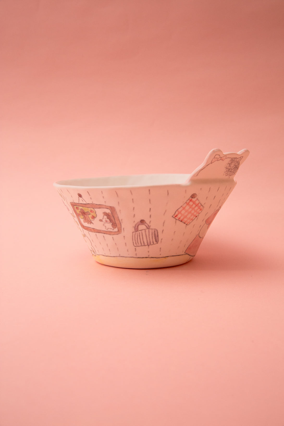 Ceramic bowl with patterns on a pink background