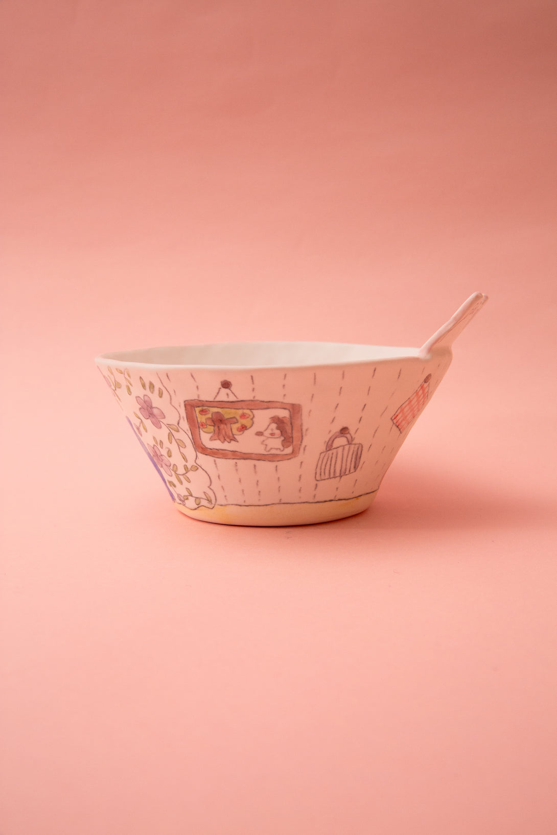 Ceramic bowl with floral patterns on a pink background