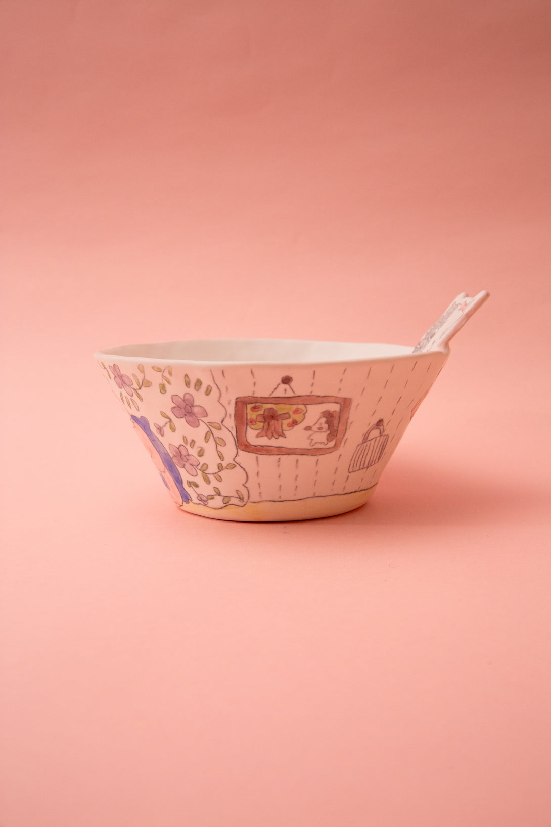Ceramic bowl with floral patterns on a pink background