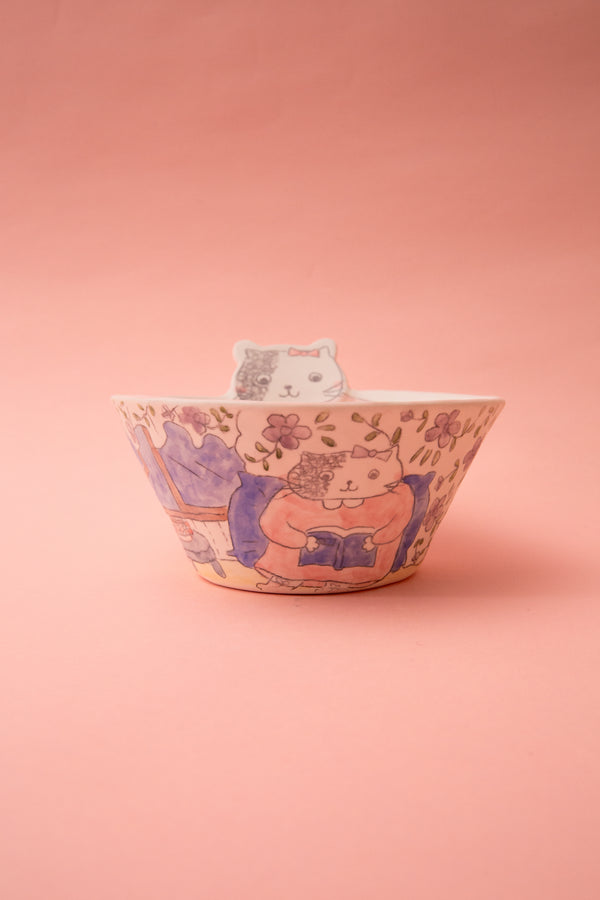 Ceramic bowl with cat design on a pink background