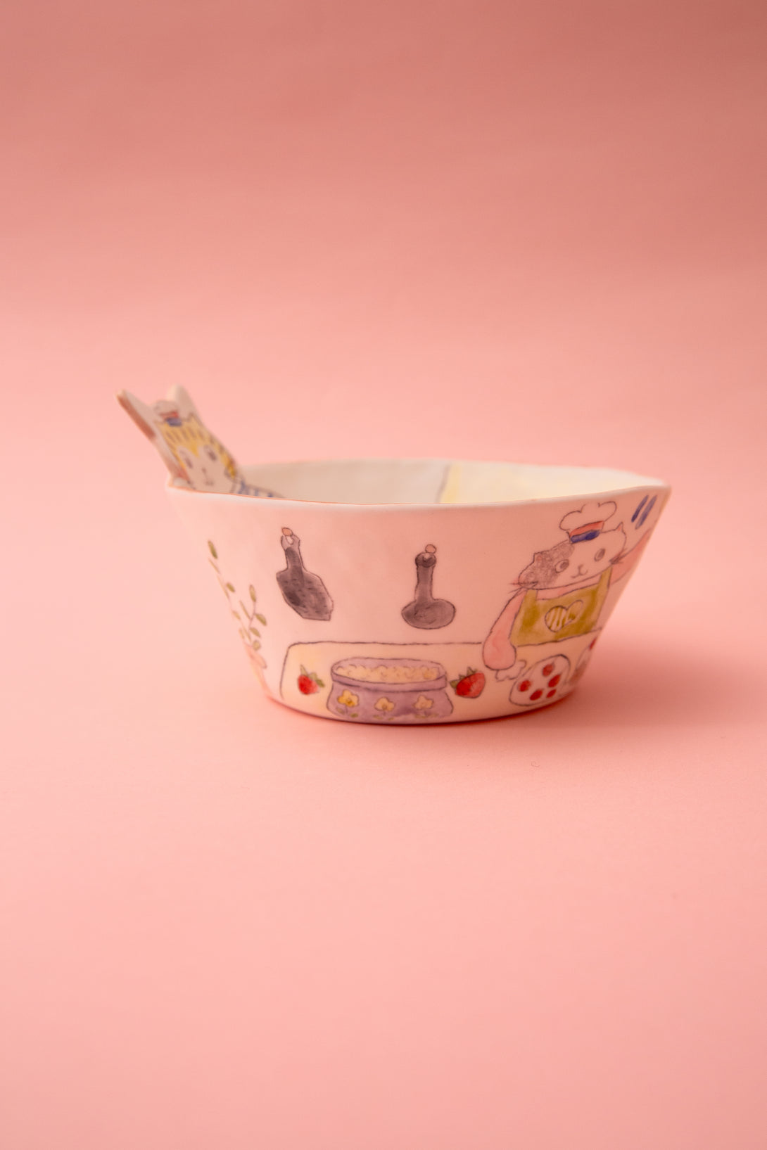Ceramic bowl with cartoon character design on a pink background