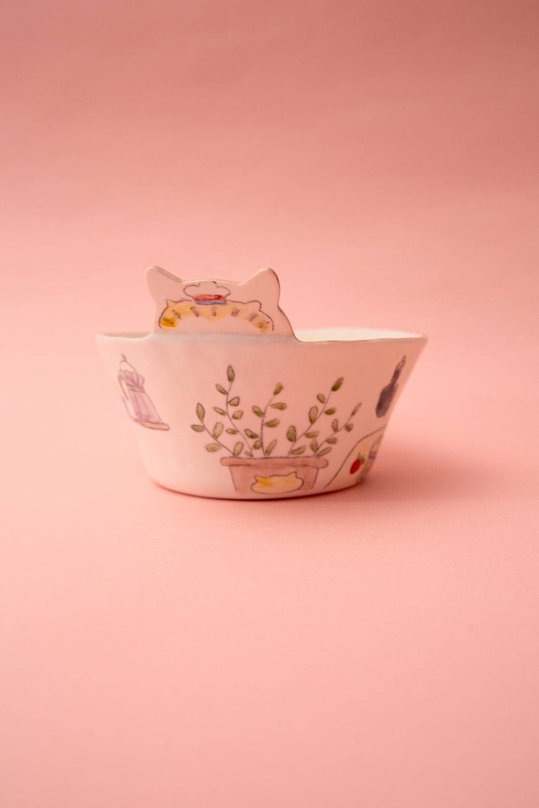 Ceramic bowl with floral design on a pink background