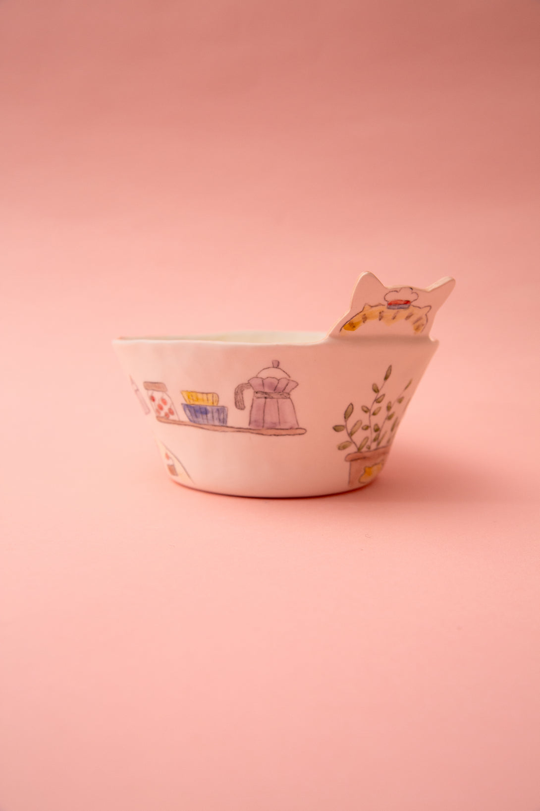 Ceramic bowl with cartoon designs on a pink background