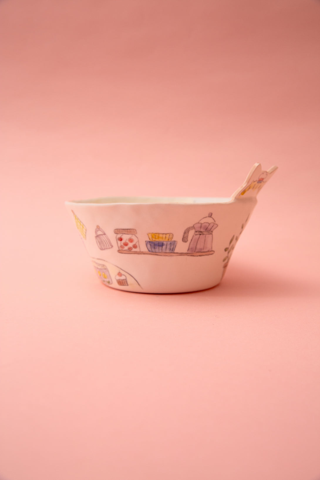 Ceramic bowl with illustrations on a pink background