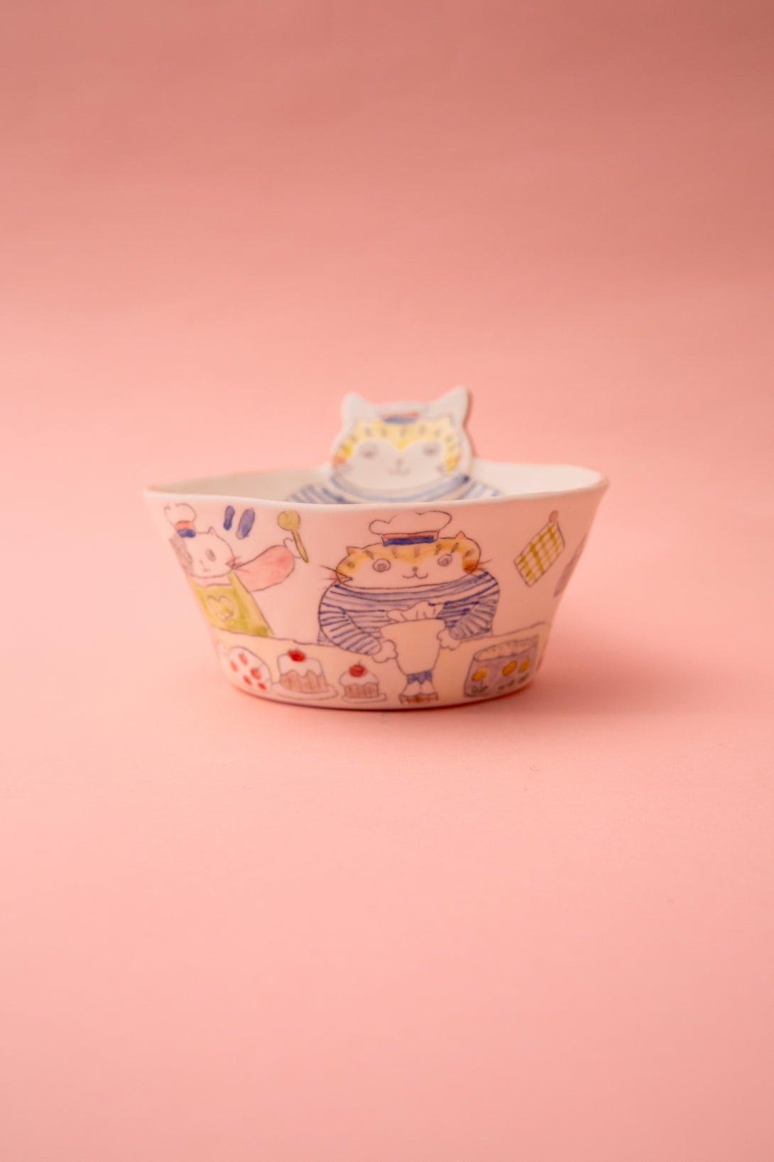 Ceramic bowl with cat design on a pink background