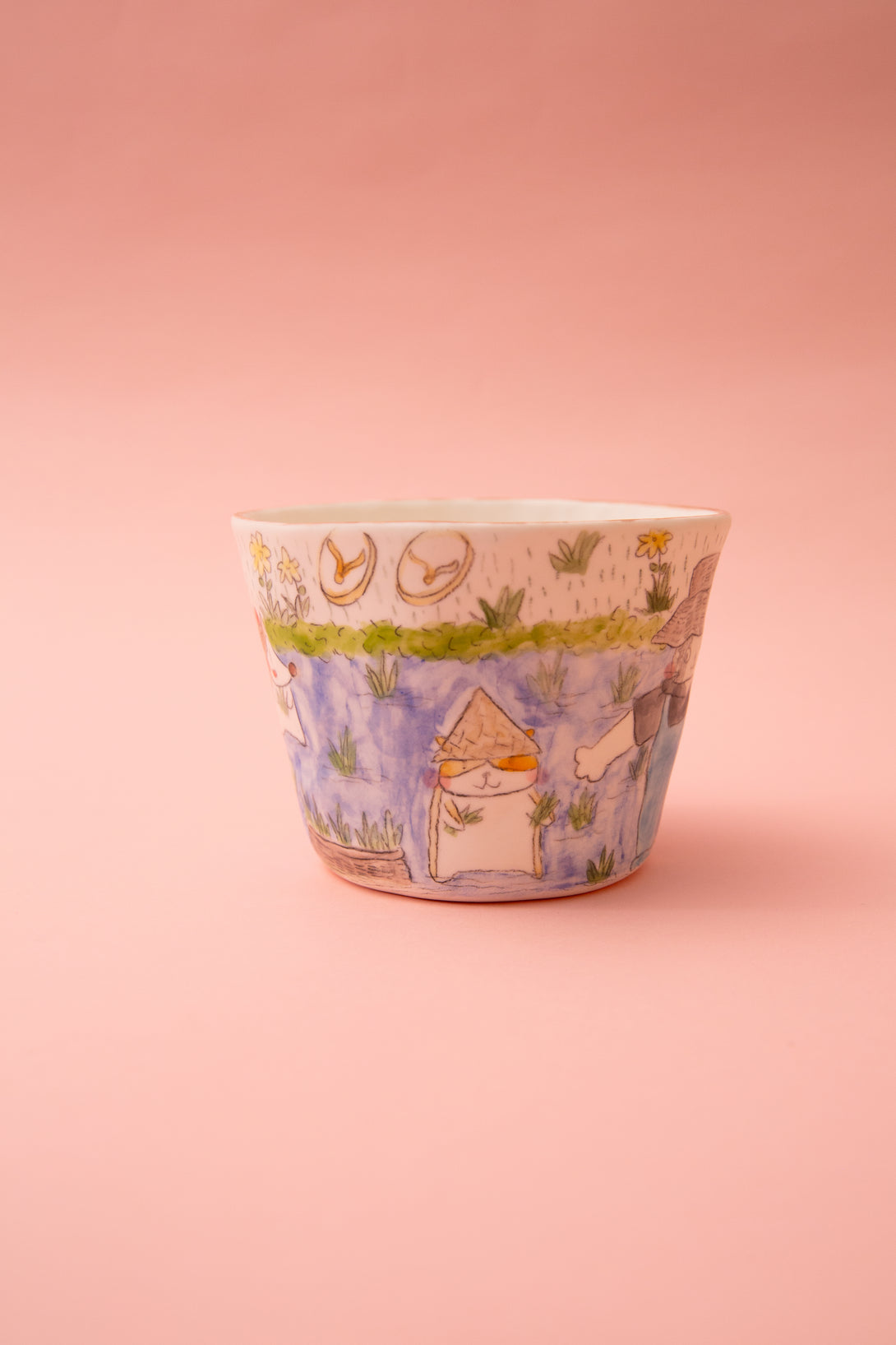 Ceramic cup with illustrations on a pink background