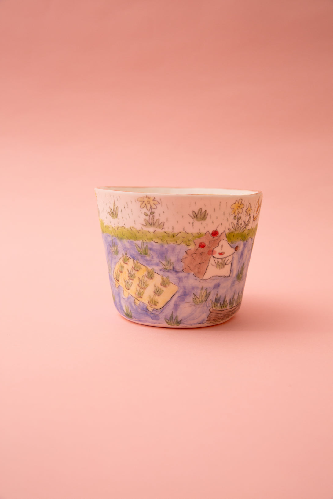 Ceramic mug with a cartoon daesign on a pink background