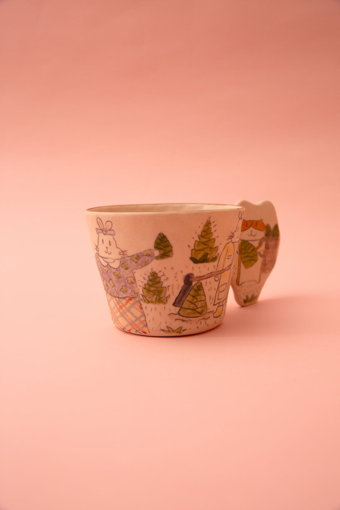 Ceramic cup with illustrations on a pink background