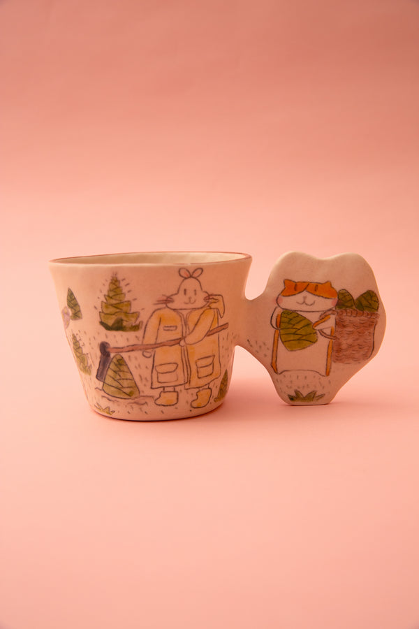 Ceramic cup with a cartoon character and a fun handle design on a pink background
