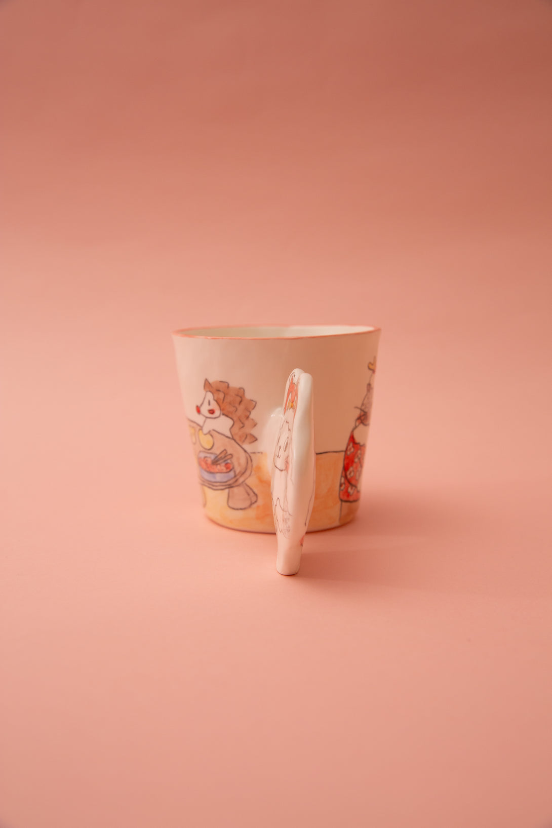 Ceramic mug with a design on a pink background