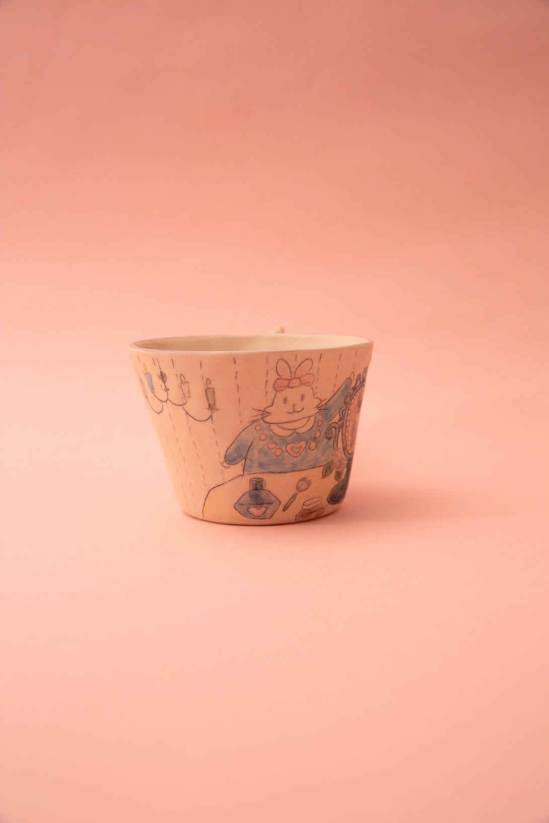Ceramic mug with a design on a pink background