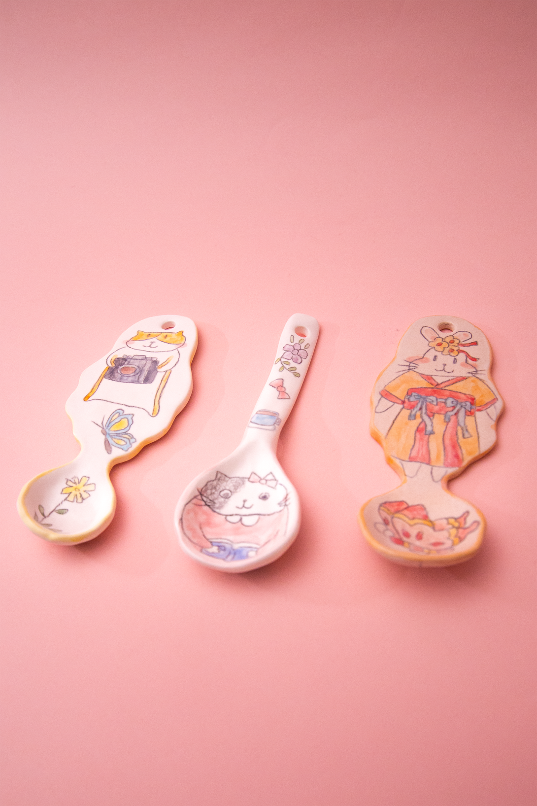 Three spoons on a pink background