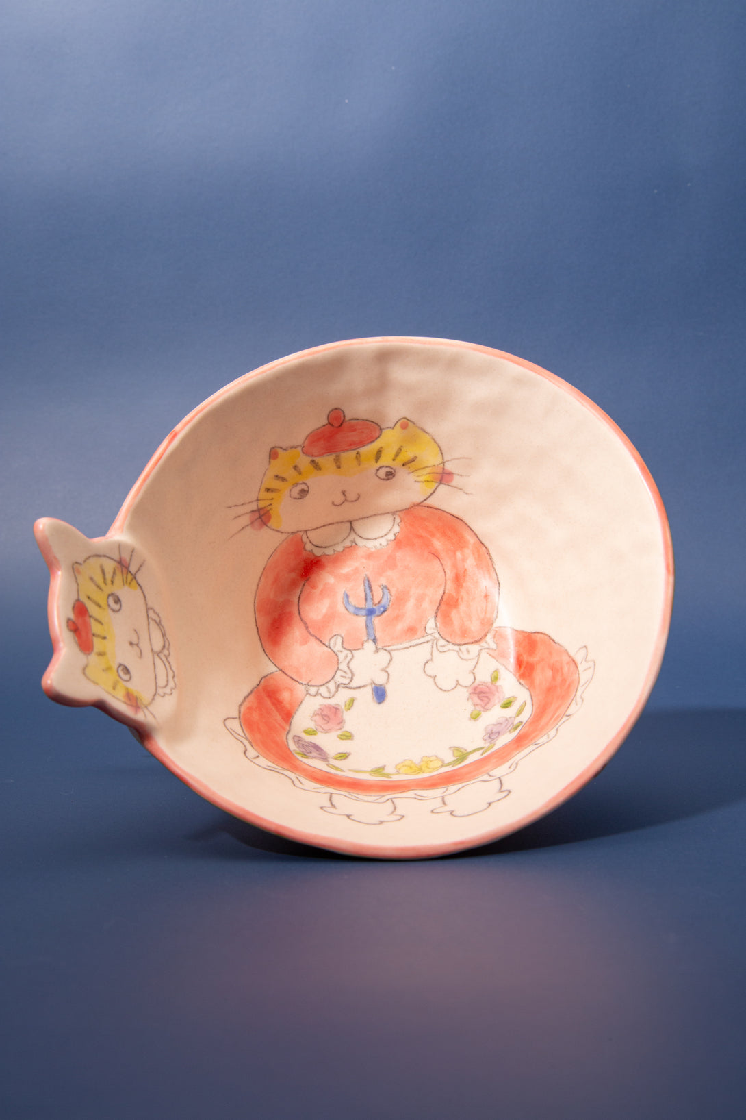 Ceramic bowl with a cartoon character design on a blue background