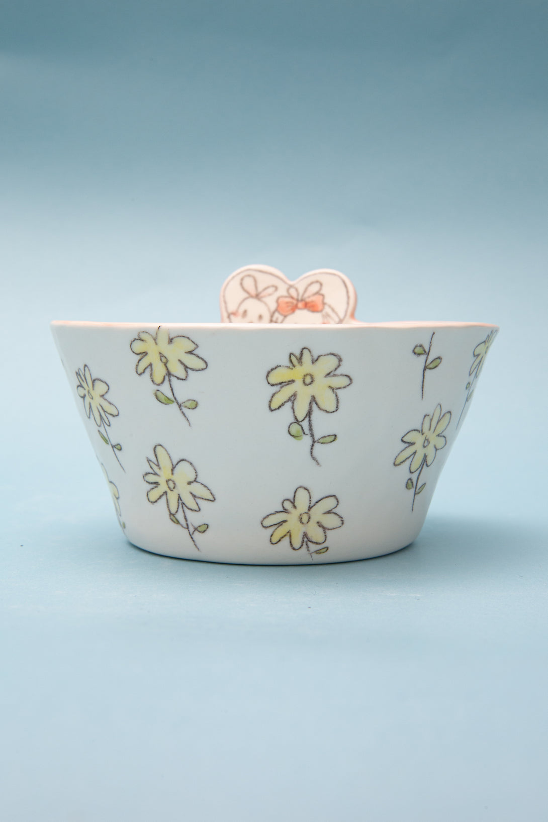 Ceramic bowl with floral patterns on a light blue background