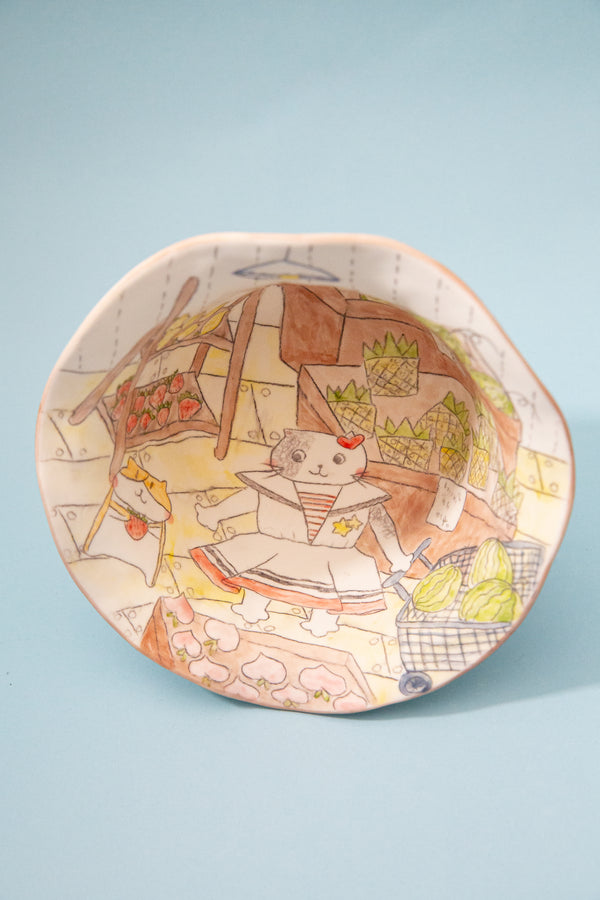 bowl with a cartoon character and colorful design on a light blue background