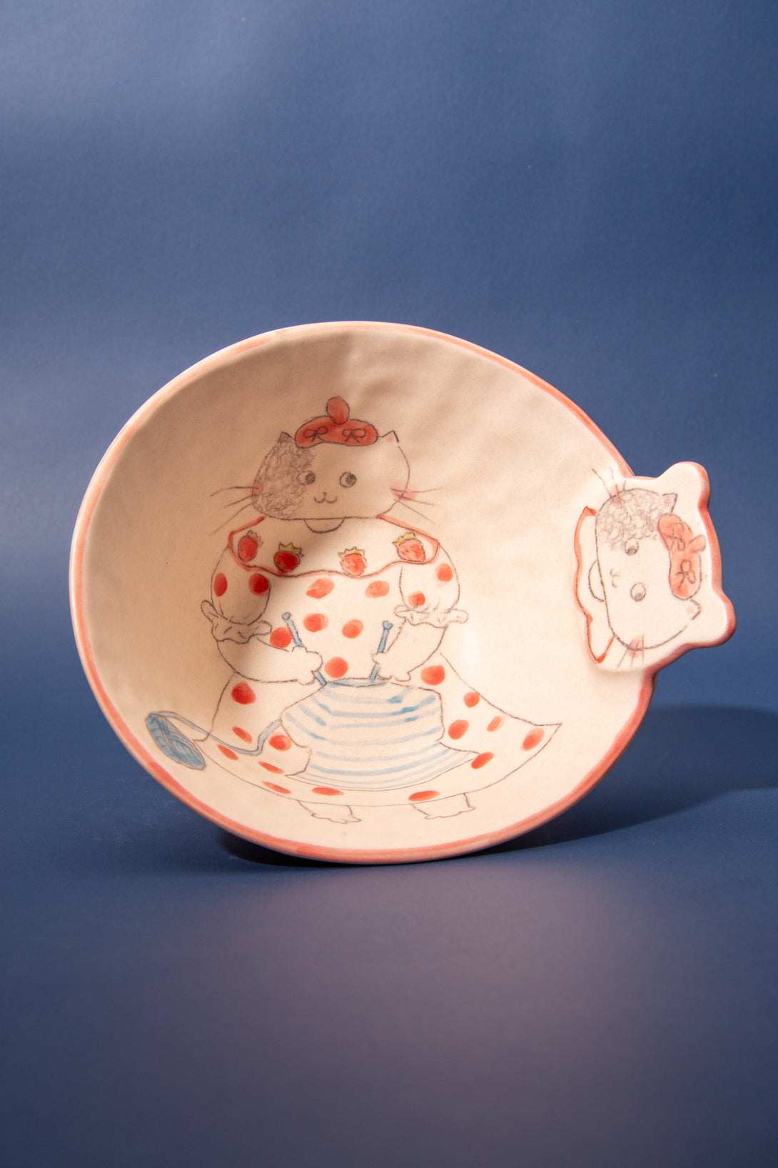 Ceramic bowl with a cartoon character design on a blue background