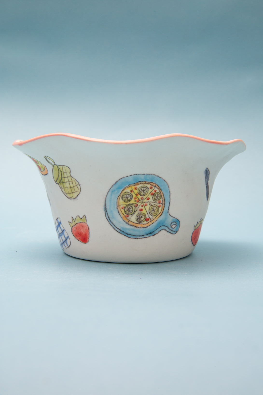 ceramic bowl with colorful designs on a light blue background