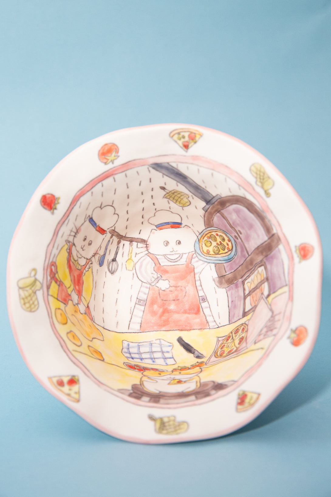 Decorative bowl with cartoon characters on a blue background