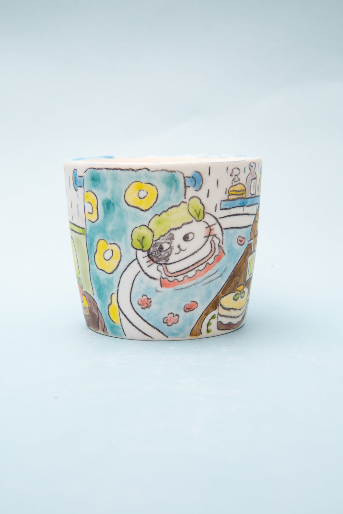 Ceramic cup with cartoon design on a light blue background