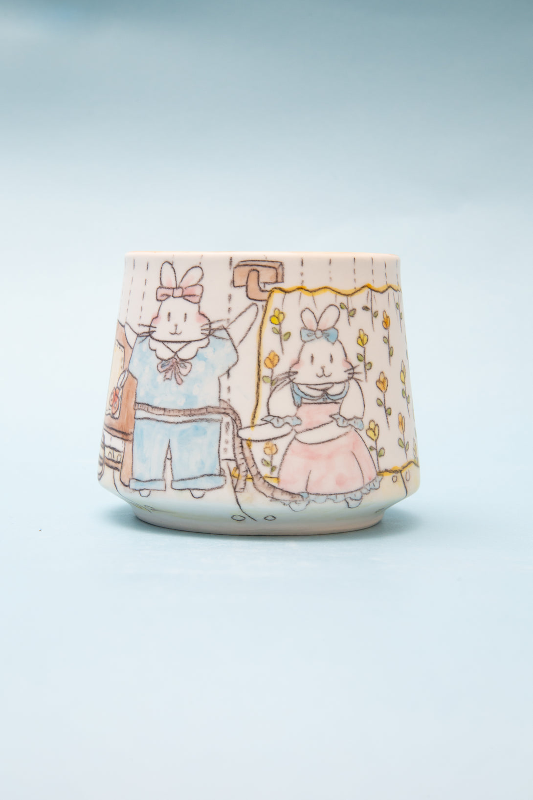 Ceramic mug with cartoon characters on a light blue background