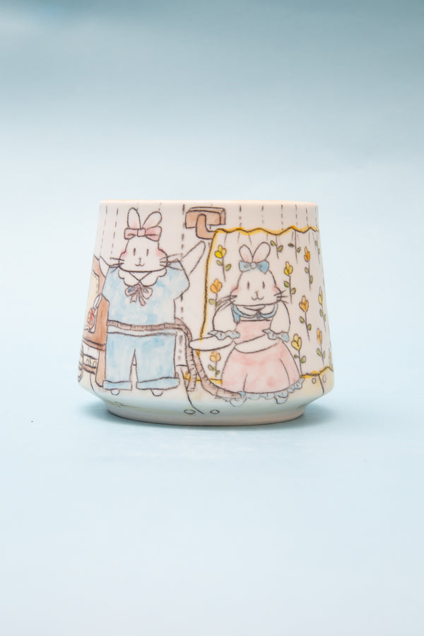 Ceramic mug with cartoon characters on a light blue background