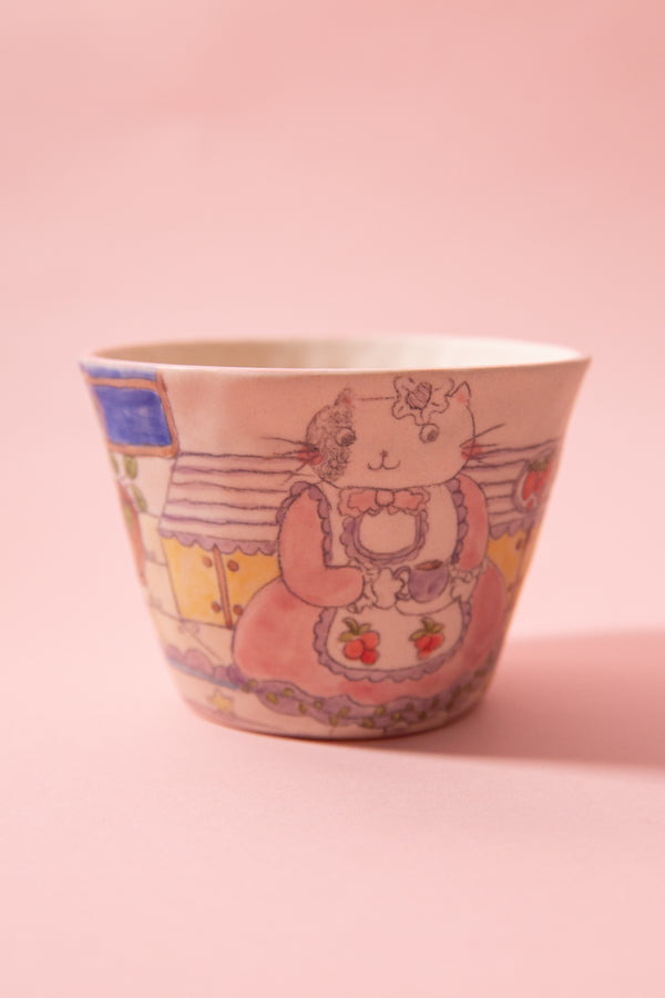 Ceramic cup with cat design on a pink background
