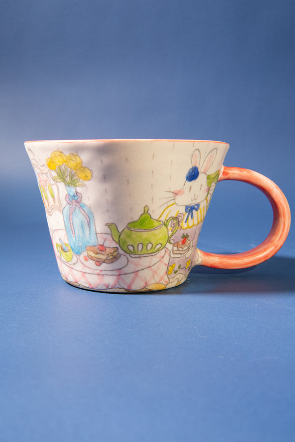 Ceramic mug with colorful illustrations on a blue background