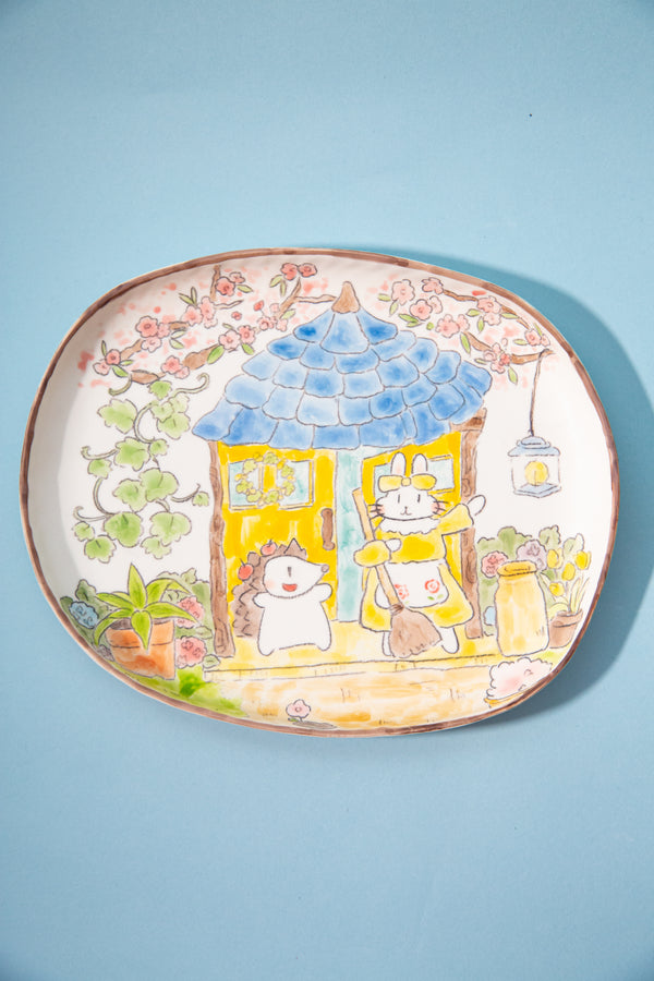 plate with cartoon characters and a garden scene on a light blue background