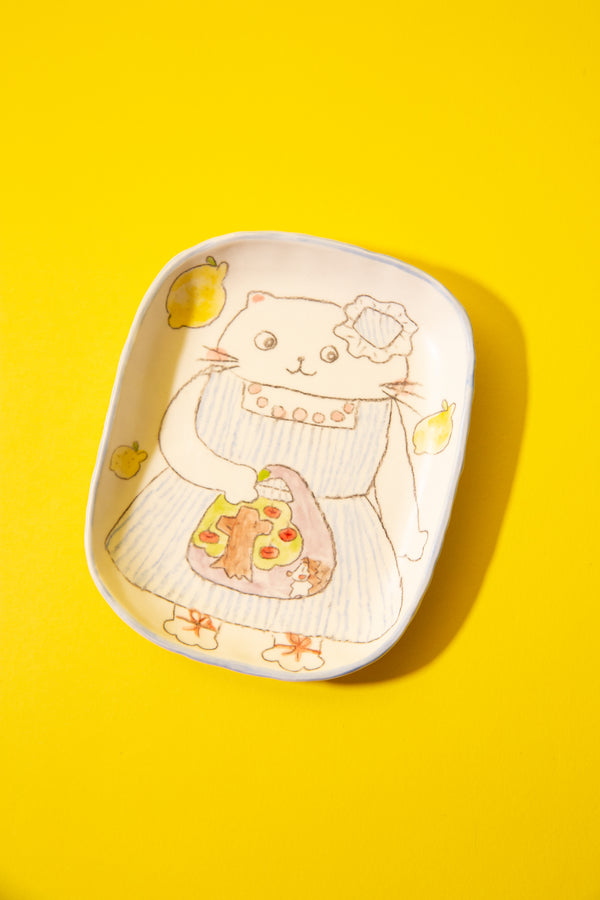 Ceramic plate with a cute cat design on a yellow background