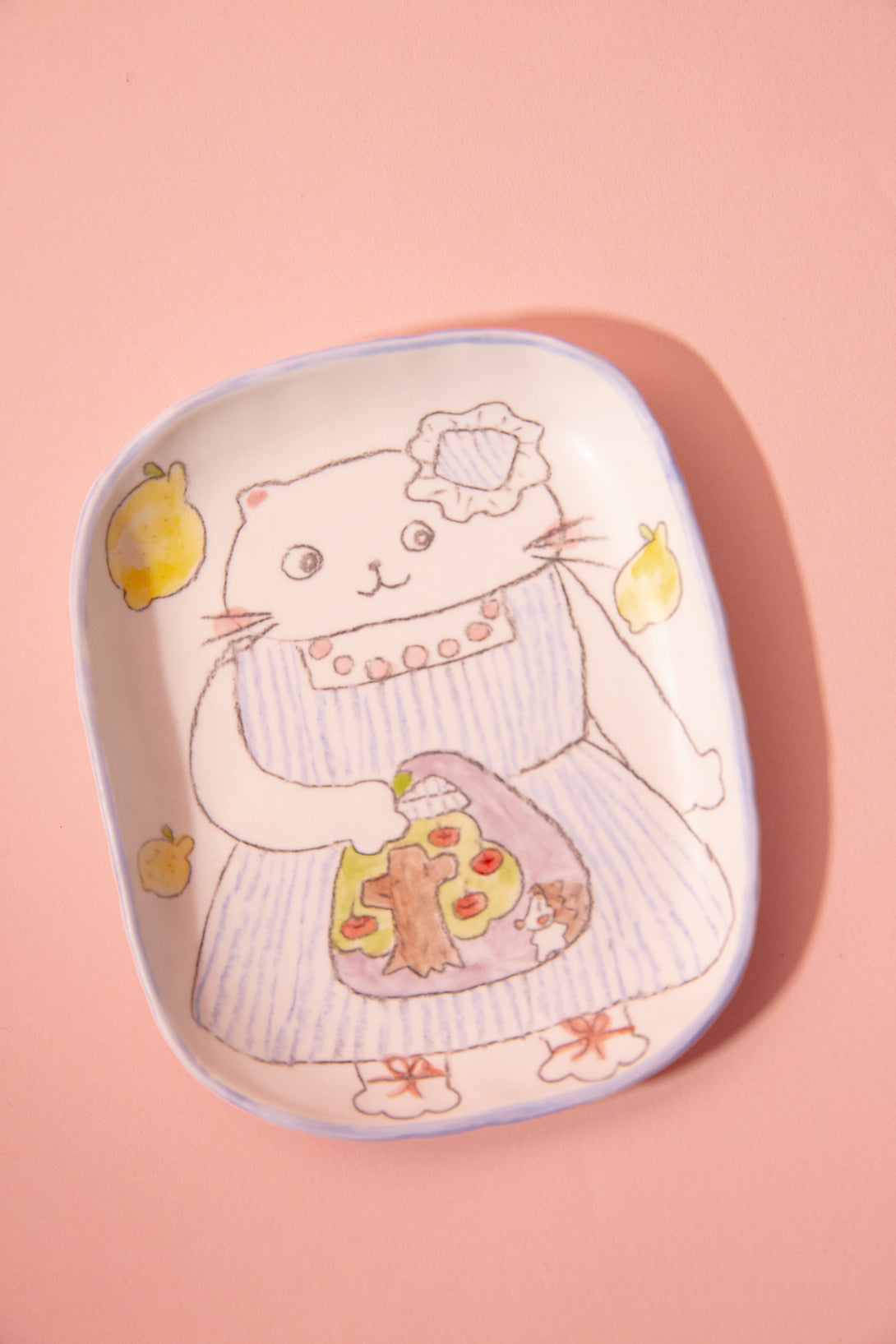 Ceramic plate with a cute cat design on a pink background