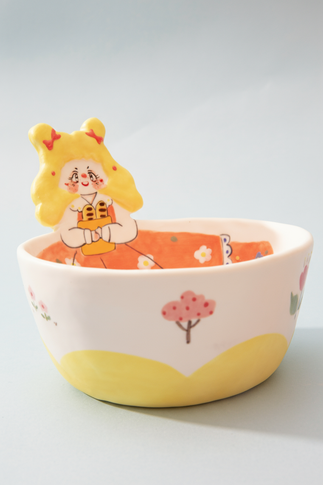 Ceramic bowl with cartoon character on a light gray background