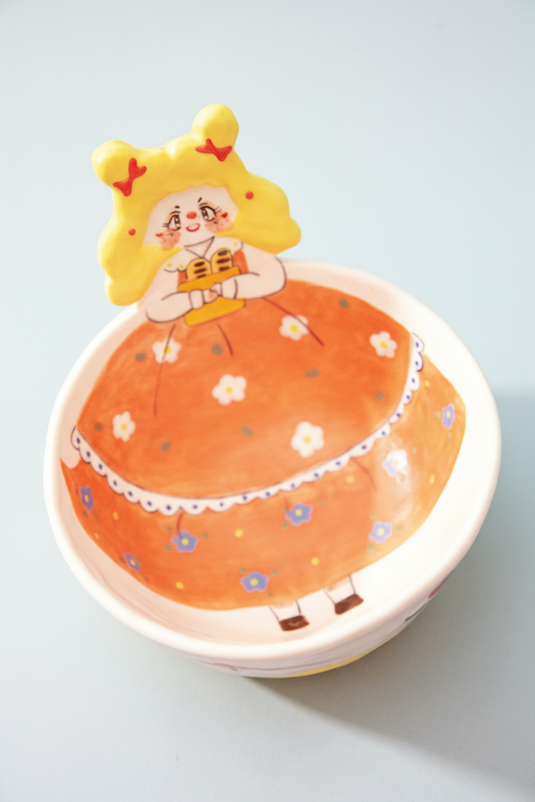 bowl with a cartoon character on an orange background