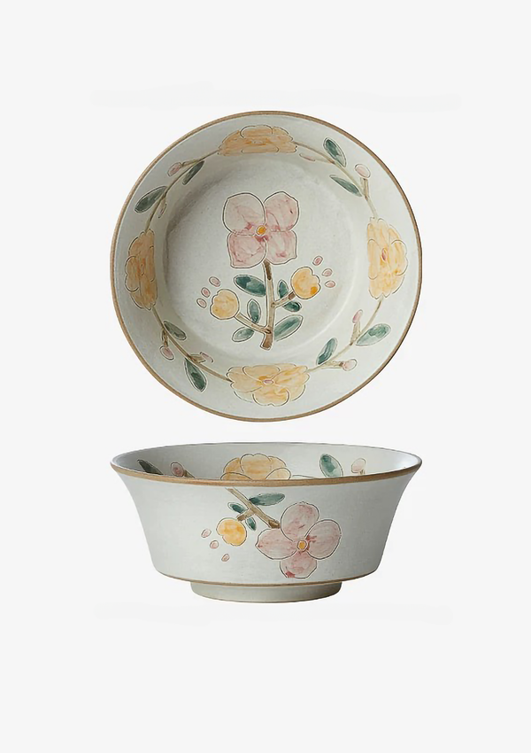 ceramic bowl with floral patterns in beige, white, and green colors.