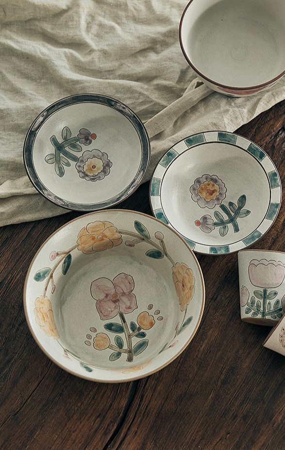 ceramic bowls with floral patterns in beige, white, and green colors.