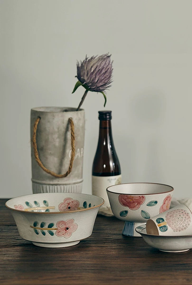 ceramic bowl with floral patterns in beige, white, and green colors.