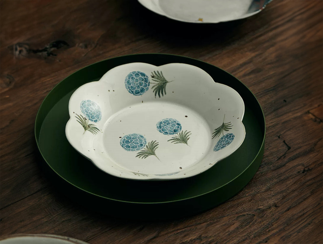 white ceramic plate with blue floral patterns in the center.