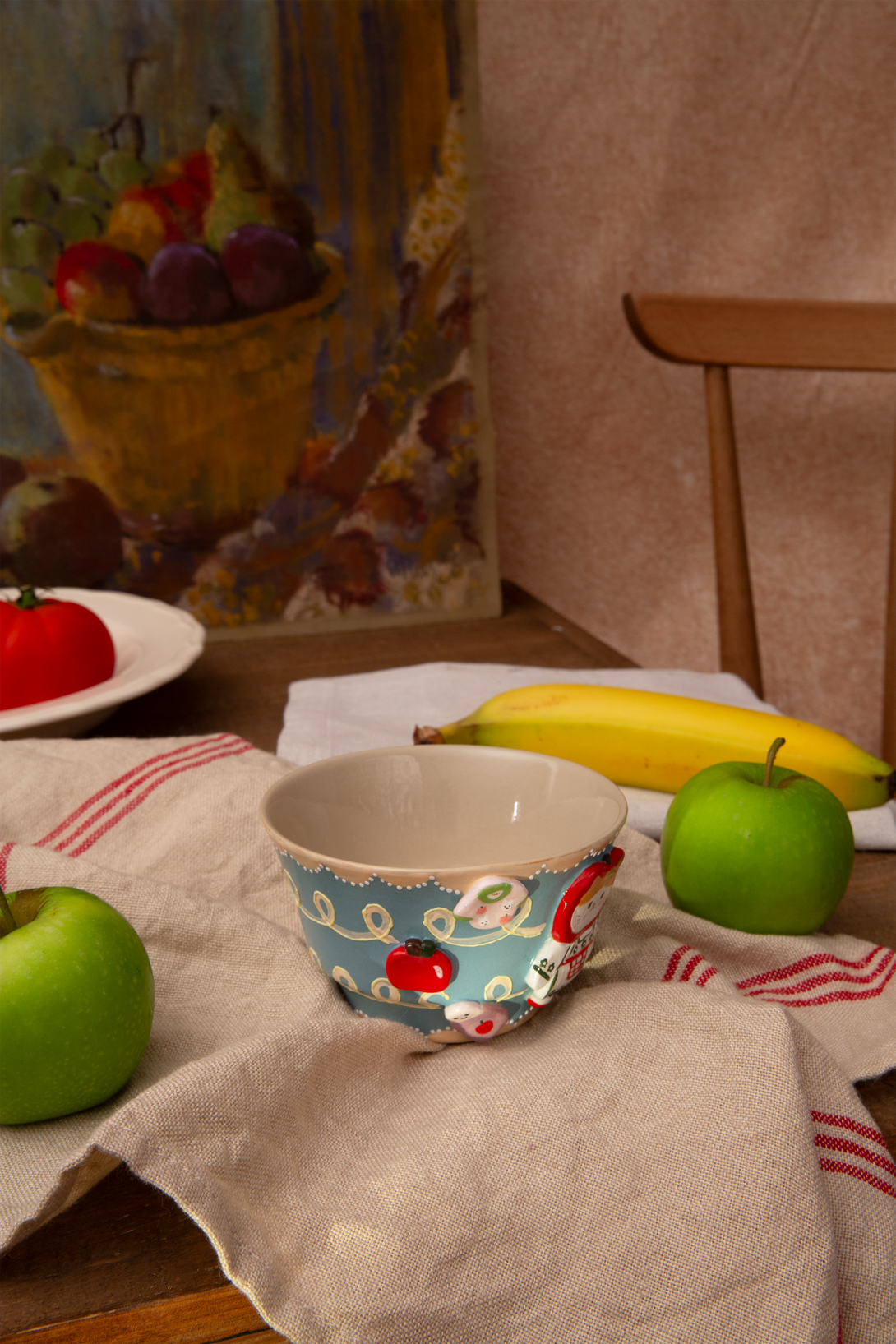bowl with cartoon 3d design on a tablecloth with apples and bananas